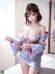 A woman in a kimono is posing on a bed.