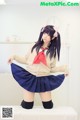 A woman in a school uniform posing for a picture.