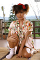 A woman in a kimono sitting on the floor.