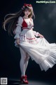A woman in a white dress and red shoes posing for a picture.